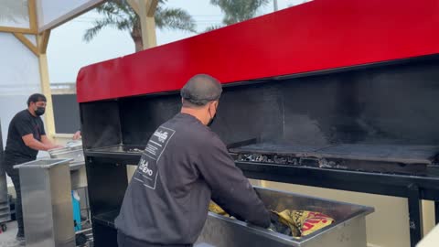 اشعال الفحم لطهي المشويات في احدى المطابخ المشاركة، أنواع المطابخ المختلفة المشاركة في المهرجان، مهرجان إثراء للطعام يقام في حدائق مركز الملك عبد العزيز الثقافي العالمي من ٢٢ ديسمبر حتى ع يناير ٢٠٢٦ في المملكة العربية السعودية