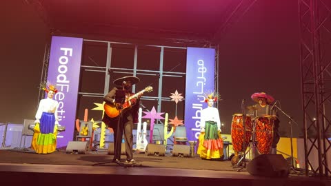 Performers wear colorful costumes and decorated heads, the Ithra Food Festival from December 22 to January 1, 2026, a Mexican folk dance, King Abdulaziz Center for World Culture (Ithra) in Dhahran, Saudi Arabia, a unique design resembling pebbles.