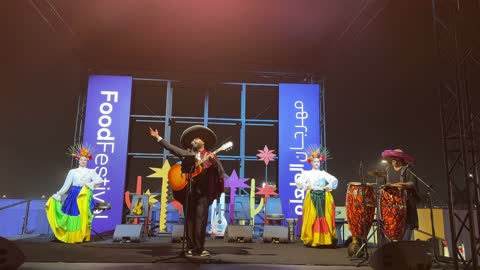 Performers wear colorful costumes and decorated heads, the Ithra Food Festival from December 22 to January 1, 2026, a Mexican folk dance, King Abdulaziz Center for World Culture (Ithra) in Dhahran, Saudi Arabia, a unique design resembling pebbles.