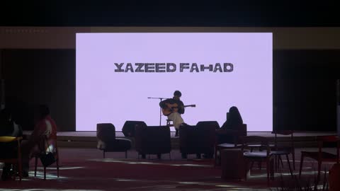 A musician playing the guitar at the winter bazaar at night in the Diplomatic Quarter in Riyadh from December 11, 2025, to January 3, 2026. A warm family winter atmosphere, an enjoyable shopping and entertainment event, a unique winter shopping experience that combines handicrafts.