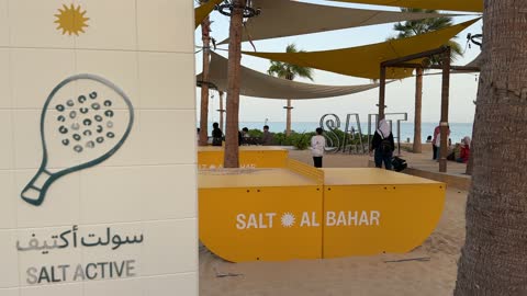 Recreational events and activities at Salt Beach on the Corniche in Al Khobar, Eastern Province, Saudi Arabia, tourist restaurants and cafes, a calm atmosphere and a pleasant relaxation experience, sea-view seating, a family-friendly coastal beach destination.