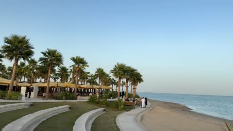 Seaside seating, events and recreational activities, the sea at the Corniche of Khobar in the Eastern Province, Kingdom of Saudi Arabia, tourist restaurants and cafes, a calm atmosphere and a pleasant relaxation experience, a family-friendly coastal beach destination.