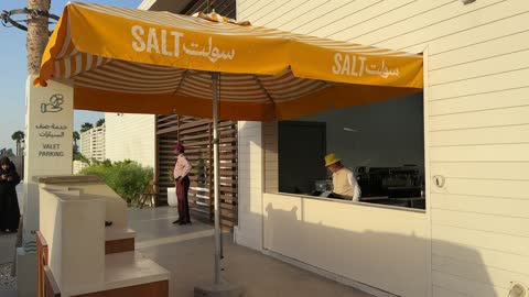 Car parking service at Salt Beach on the Corniche in Al Khobar, Eastern Province, Saudi Arabia, with sea-view seating, a family-friendly coastal beach destination, a calm atmosphere, and a pleasant relaxation experience, entertainment events and activities, tourist restaurants and cafes.