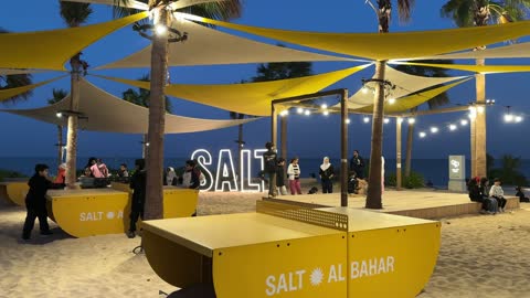 A calm atmosphere and a pleasant relaxation experience at Salt Beach on the Corniche in Al Khobar, Eastern Province, Saudi Arabia, with entertainment events and activities, a family-friendly coastal beach destination, tourist restaurants and cafes, and sea-view seating.