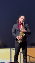 A musical performance and saxophone playing at a food festival in the outdoor gardens of Ithra in Dhahran, Eastern Province, Saudi Arabia, on December 28, 2025. International and local restaurants, enjoyable outdoor seating, a global dining experience, and family-friendly and entertaining atmosphere.