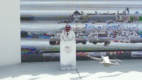 Delivering a speech and announcing the start of the race, the championship and sports activities in the city of Tabuk, the rally race event in the Kingdom of Saudi Arabia, the speed race for cars, the competition and rivalry to achieve victory, the turns and directions for the competing cars.