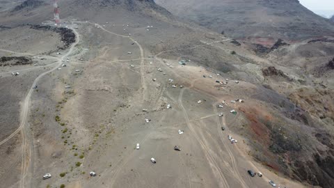 Four-wheel drive vehicles in a desert area, dormant volcanic fields with rugged terrain, important tourist and geological sites, archaeological inscriptions and rock formations, trade caravan routes, volcanic fields in Tabuk, laboratories on ancient volcanic activity in the Kingdom of Saudi Arabia.