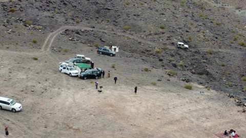 Trade caravan routes, important archaeological and geological sites with rock formations, dormant volcanic fields with rugged terrain, four-wheel drive vehicles in a desert area, the volcanic fields in Tabuk are laboratories for ancient volcanic activity in the Kingdom of Saudi Arabia.