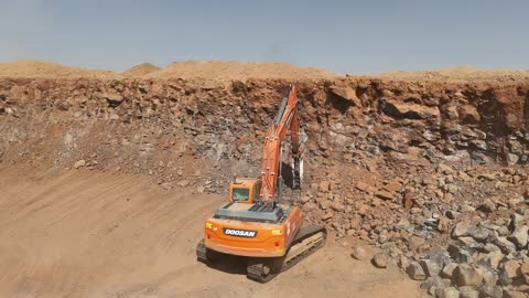 Mechanisms within soil movement operations, large-scale mining in a desert area, a cement factory or quarry in the Kingdom of Saudi Arabia, mixing concrete components, cement paste for construction and building, construction sites, concrete barriers to separate stored materials.