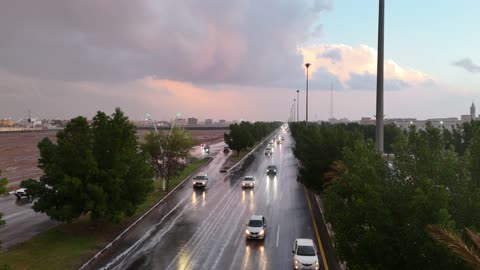 Wide areas of wet land, lightning is a strip of light piercing the sky quickly, a low-pressure system, winter rains, tourist places and areas in the Kingdom of Saudi Arabia, drone footage of the flood in the city of Tabuk, rainwater accumulation in the middle of the area.