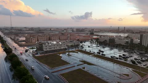 People wearing winter clothes and off-road vehicles, the Al-Harra mountain range in the Tabuk region covered in snow, cold snowy atmosphere, sculpted mountains and geological formations in the city of Tabuk, cultural and tourist landmarks in the Kingdom of Saudi Arabia, aerial drone photography of rock formations.