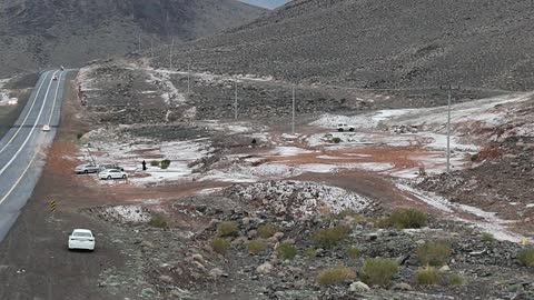 The Al-Harra mountain range in the Tabuk region is covered in snow, with cold snowy weather, sculpted mountains, and geological formations in the city of Tabuk. It features cultural and tourist landmarks in the Kingdom of Saudi Arabia, with aerial drone photography of the rock formations.