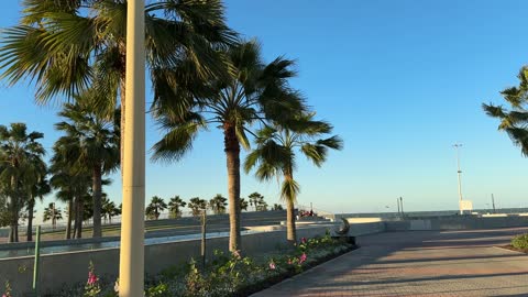 A coastal promenade with outdoor seating, a tourist and entertainment landmark overlooking the Arabian Gulf, the waterfront in the city of Dammam, Eastern Province, Saudi Arabia, offers various recreational and sports activities, restaurants and cafes with sea views, and a calm and unique family atmosphere.