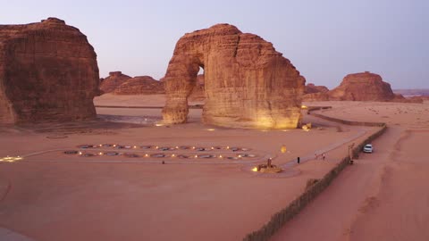 A famous desert area, drone photography of the Elephant Rock in Saudi Arabia, ancient civilization and archaeological historical landmarks, mountain peaks and highlands, rock formation and composition in the city of AlUla.