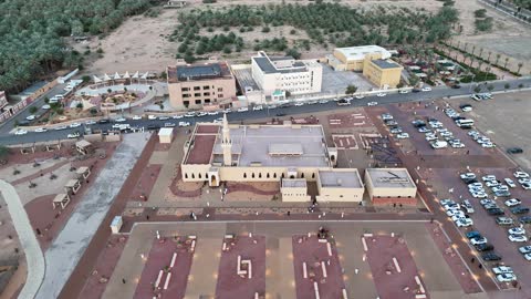 Trees and green plants, architectural art in the Islamic style, a famous tourist area, mountains and rock formations, a place for worship and getting closer to God Almighty, drone photography of an Islamic mosque in Al-Ula Governorate in the Kingdom of Saudi Arabia.
