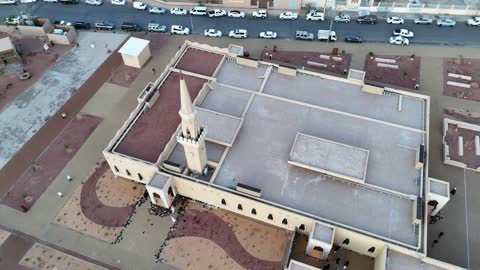 Islamic architectural engineering art, a famous tourist area, mountains and rock formations, a place for worship and getting closer to God Almighty, drone photography of an Islamic mosque in Al-Ula Governorate in the Kingdom of Saudi Arabia, trees and green plants.