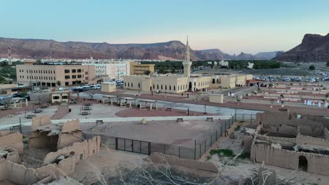 A famous tourist area, mountains and rock formations, a place for worship and getting closer to God Almighty, drone footage of an Islamic mosque in Al-Ula Governorate in the Kingdom of Saudi Arabia, trees and green plants.