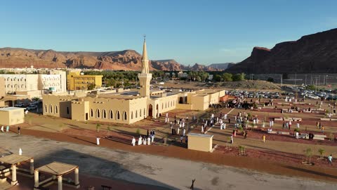 A famous tourist area, mountains and rock formations, a place for worship and getting closer to God Almighty, drone footage of an Islamic mosque in Al-Ula Governorate in the Kingdom of Saudi Arabia, trees and green plants.