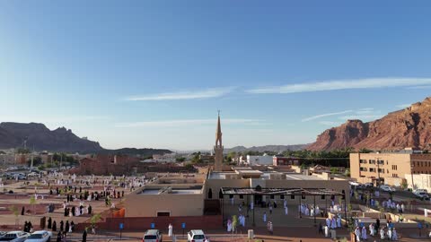 Islamic architectural engineering art, a famous tourist area, mountains and rock formations, a place for worship and getting closer to God Almighty, drone photography of an Islamic mosque in Al-Ula Governorate in the Kingdom of Saudi Arabia, trees and green plants.