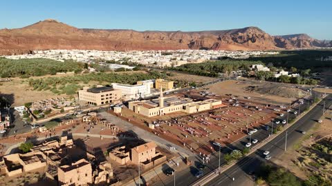 A famous tourist area, mountains and rock formations, a place for worship and getting closer to God Almighty, drone footage of an Islamic mosque in Al-Ula Governorate in the Kingdom of Saudi Arabia, trees and green plants.