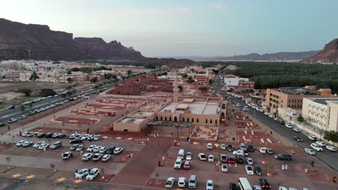 A place for worship and getting closer to God Almighty, trees and green plants, architectural art in the Islamic style, a famous tourist area, mountains and rock formations, drone photography of an Islamic mosque in Al-Ula Governorate in the Kingdom of Saudi Arabia.