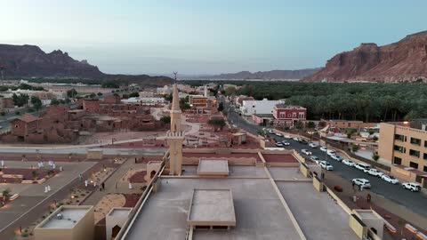 A place for worship and getting closer to God Almighty, trees and green plants, architectural art in the Islamic style, a famous tourist area, mountains and rock formations, drone photography of an Islamic mosque in Al-Ula Governorate in the Kingdom of Saudi Arabia.