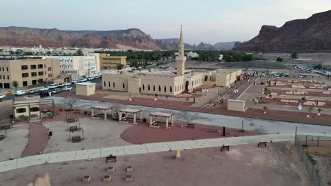 A place for worship and getting closer to God Almighty, trees and green plants, architectural art in the Islamic style, a famous tourist area, mountains and rock formations, drone photography of an Islamic mosque in Al-Ula Governorate in the Kingdom of Saudi Arabia.