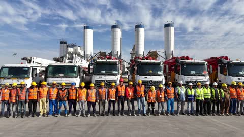 Working in an industrial environment, vehicles for transporting ready-mixed concrete from the factory to construction sites, producing concrete for construction and civil engineering projects, a factory specialized in ready-mixed concrete and mechanical foundations, mixing concrete components, cement paste for construction and building.