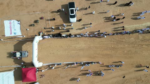 The presence of logos for a car company, competing in diverse terrains in Tabuk, the rally racing event in the Kingdom of Saudi Arabia, car speed racing, preparing the venue for enjoyable recreational youth sports, the turns and directions for the competing cars.