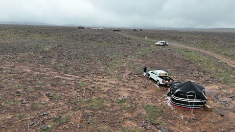 Visitors to enjoy the cold snowy atmosphere, the Al-Harra mountain range in the Tabuk region is covered in snow, sculpted mountains and geological formations, cultural and tourist landmarks in the Kingdom of Saudi Arabia, aerial drone photography of the rock formations.