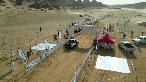 The presence of logos for a car company, competing in diverse terrains in Tabuk, the rally racing event in the Kingdom of Saudi Arabia, car speed racing, preparing the venue for enjoyable recreational youth sports, the turns and directions for the competing cars.