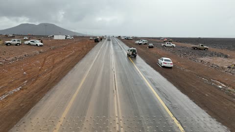 Visitors to enjoy the cold snowy atmosphere, the Al-Harra mountain range in the Tabuk region is covered in snow, sculpted mountains and geological formations, cultural and tourist landmarks in the Kingdom of Saudi Arabia, aerial drone photography of the rock formations.