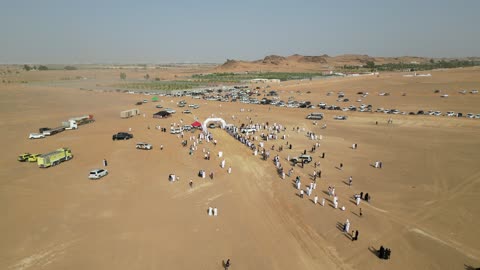 The sport of off-roading with dirt cars in desert areas, racing on soft golden sands, exciting challenges and recreational activities, famous competitions and events, aerial drone photography of the Dakar Rally in Saudi Arabia, World Rally Championship.