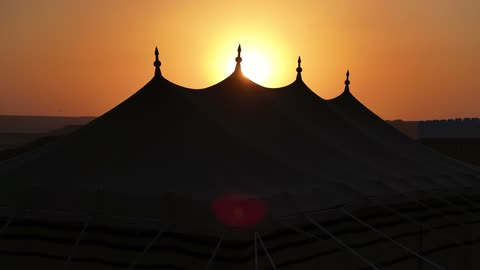 A sunset shot of a famous Saudi historical cultural and tourist landmark at night, the illuminated Al-Bujairi Park and Overlook during the day, the development project of historical Diriyah in the city of Riyadh, Saudi Arabia, the heritage village and archaeological buildings.