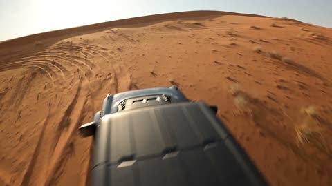 A quad bike in the middle of the desert, spending time in the desert with friends, the natural scenery and soft golden sands in the desert, the soft golden dunes and natural terrain in the Kingdom of Saudi Arabia, nature background.