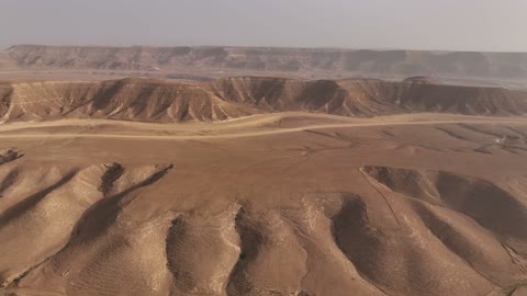 The natural terrain in the desert, the landscapes and soft golden sands in the desert, the soft golden dunes and natural terrain in the Kingdom of Saudi Arabia, rock formations in the Saudi Arabian desert, nature background.
