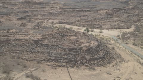 The formation and sandy shaping in the desert, the landscapes and soft golden sands in the desert, the soft golden dunes and natural terrain in the Kingdom of Saudi Arabia, rock in the Saudi Arabian desert, nature background.
