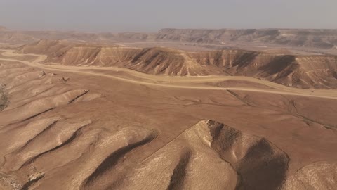The natural terrain in the desert, the landscapes and soft golden sands in the desert, the soft golden dunes and natural terrain in the Kingdom of Saudi Arabia, rock formations in the Saudi Arabian desert, nature background.
