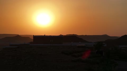 A sunset shot of a famous Saudi historical cultural and tourist landmark at night, the illuminated Al-Bujairi Park and Overlook during the day, the development project of historical Diriyah in the city of Riyadh, Saudi Arabia, the heritage village and archaeological buildings.