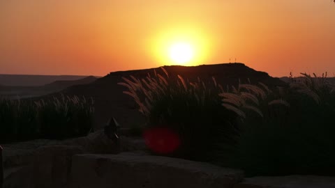 A sunset shot of a famous Saudi historical cultural and tourist landmark at night, the illuminated Al-Bujairi Park and Overlook during the day, the development project of historical Diriyah in the city of Riyadh, Saudi Arabia, the heritage village and archaeological buildings.