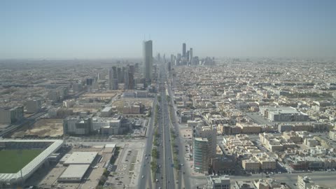 The architectural engineering art of towers and skyscrapers on King Fahd Road, aerial drone photography of the Kingdom Centre Tower in Riyadh, Saudi Arabia, famous tourist landmarks of Riyadh.