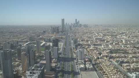 The architectural engineering art of towers and skyscrapers on King Fahd Road, aerial drone photography of the Kingdom Centre Tower in Riyadh, Saudi Arabia, famous tourist landmarks of Riyadh.