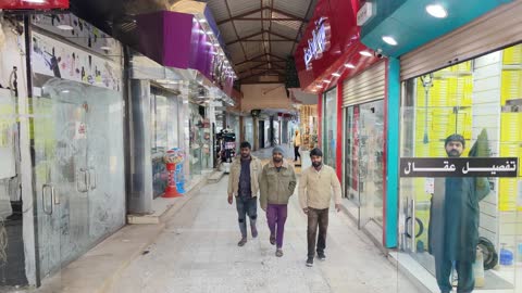 Visitors shopping in the market, with services and facilities for restrooms and parking available. The market combines authenticity and heritage, showcasing the public market in Tabuk, Saudi Arabia. A variety of shops and reasonable prices provide everything a visitor needs.