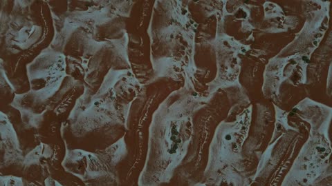 Tourist cultural landmarks in the Kingdom of Saudi Arabia, a cloudy sky, cold snowy atmosphere, the Hail mountain range, the bride of the north covered in snow, sculpted mountains and rock formations, aerial drone photography of rock formations.