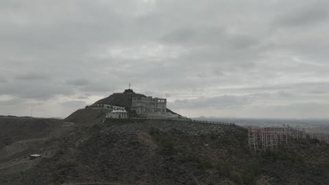 A destination that combines entertainment, heritage, and nature, a drone shot of the viewpoint of Hatim Al-Tai on Jabal Al-Samra in Hail, a historical landmark that celebrates Arab generosity and the spirit of hospitality.