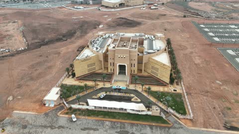 Educating visitors about the region's rich history, drone photography of the Hail Regional Museum at night in the city center of Saudi Arabia, architectural art in the old style.