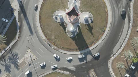 The symbol of authentic Ha'il hospitality and welcome, an artistic design in the shape of dallahs and incense burners, drone photography of the dallah roundabout in Ha'il, highlighting the region's heritage.