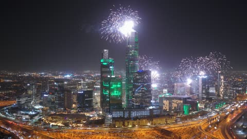 The financial towers are illuminated in green, a drone shot of the celebration at the King Abdullah Financial Center (KAFD), the architectural engineering art of the towers and skyscrapers, financial towers and economic facilities in the city of Riyadh, the growth and urban development of the famous landmarks of Riyadh.