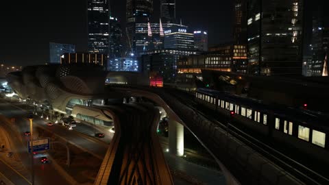 Traffic in the city of Riyadh, drone footage of the high-speed train running on the railway, the architectural engineering art of modern-style towers and skyscrapers, buildings and economic facilities in the Kingdom of Saudi Arabia, modern transportation means.