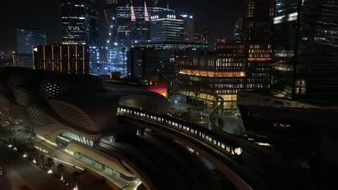 Traffic in the city of Riyadh, drone footage of the high-speed train running on the railway, the architectural engineering art of modern-style towers and skyscrapers, buildings and economic facilities in the Kingdom of Saudi Arabia, modern transportation means.